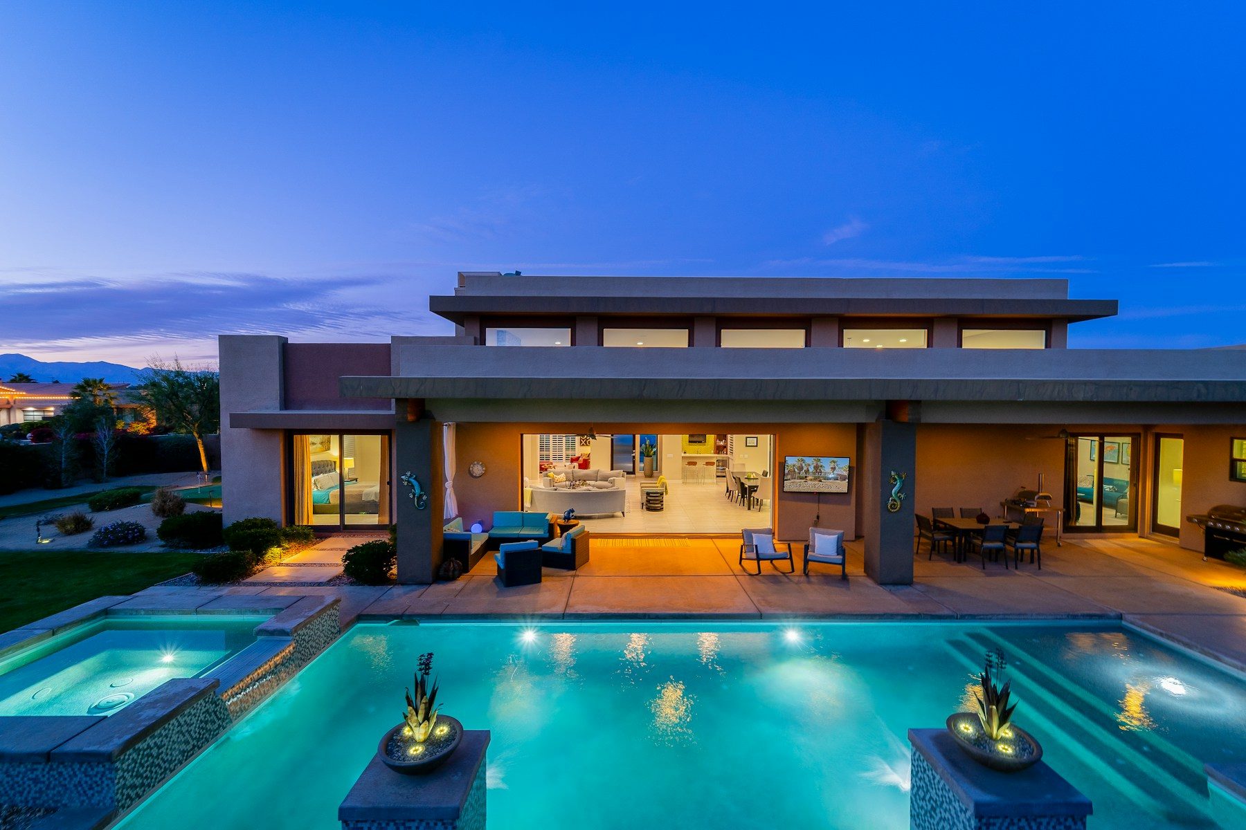 A modern custom home and pool at dusk